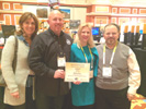 (left to right) Kidz Gears Laurie Peterson & Jack Peterson, with Karen Thomas, Thomas PR and Rick Doherty, Envisioneering Showing Off Kidz Gears Envisioneering Innovation & Design Award at Showstoppers.